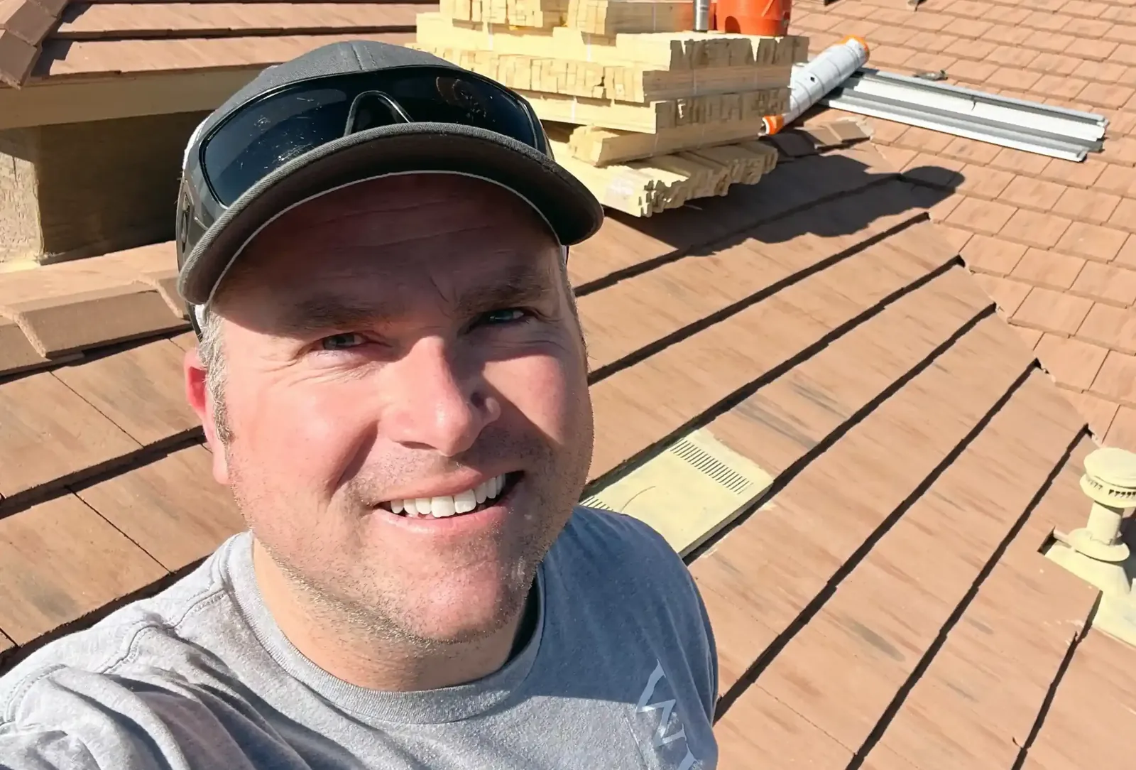 Andy Johnson, owner of White Leaf Roofing, on a tile roof in the East Valley