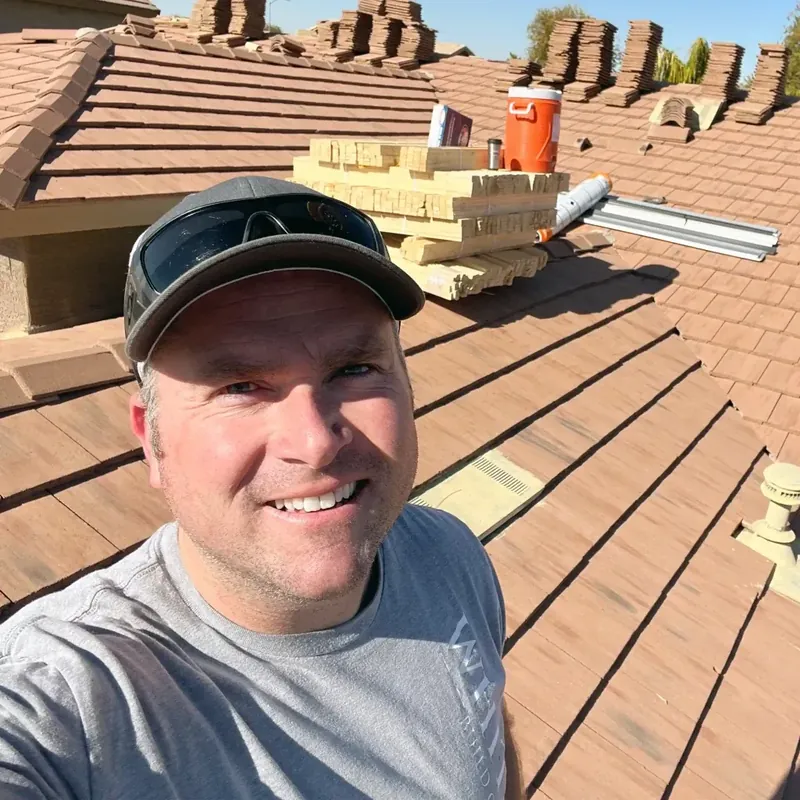 Andy Johnson, owner of White Leaf Roofing, on a tile roof in Chandler, Arizona