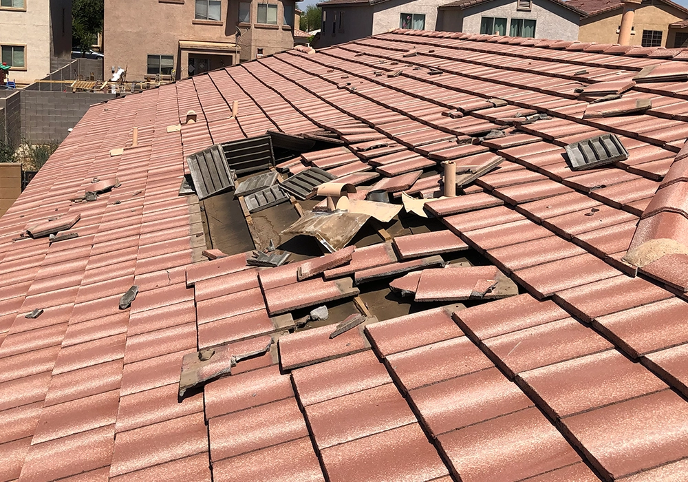 Broken tiles on an Arizona roof needing repair before sale