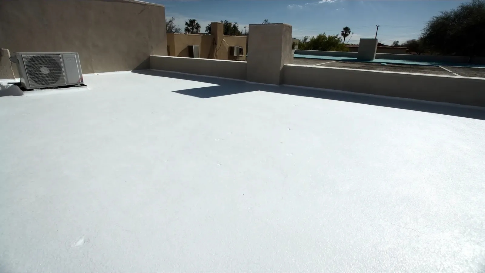 White spray foam (SPF) flat roof with elastomeric coating on an Arizona home