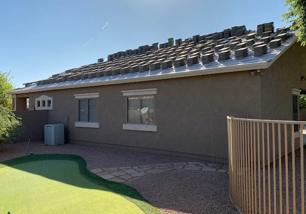 Broken roof tiles being repaired after storm damage on a Chandler home